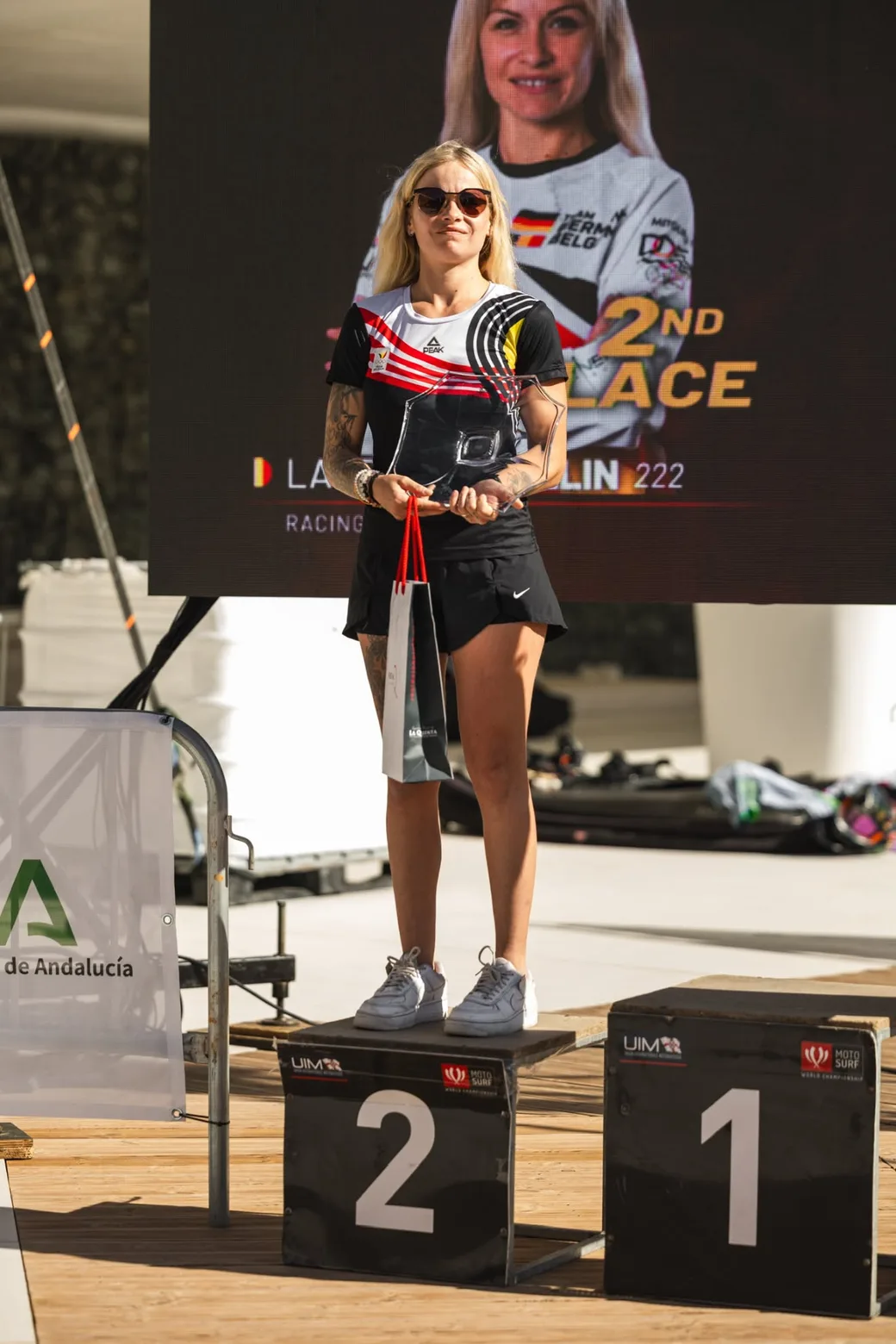 Laureen Thellin Deprez auf dem Podest mit der Trophäe, im Rücken die Anzeigetafel mit dem zweiten Platz